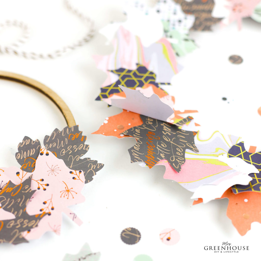 Blätter aus Papier auf Holzkranz kleben