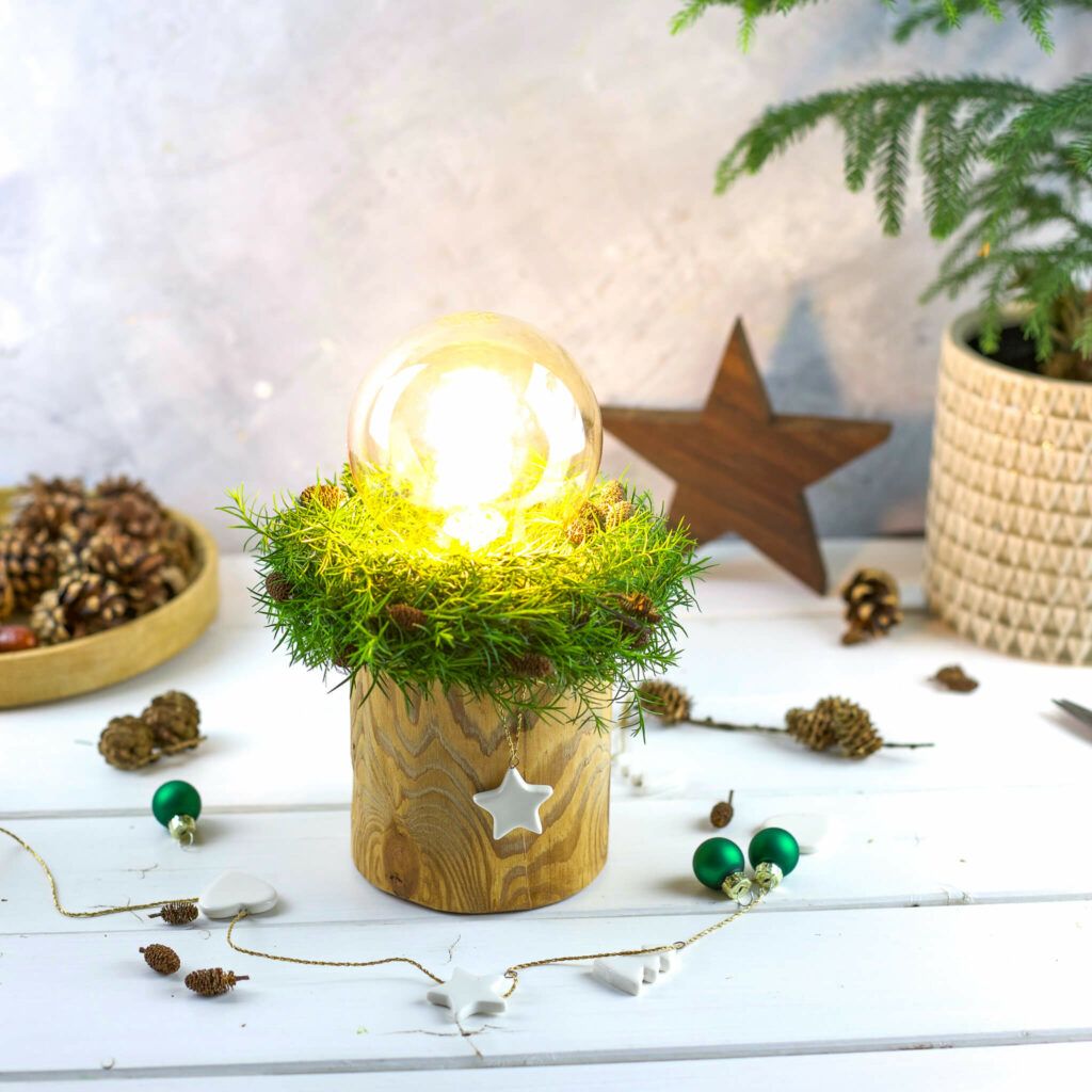 Filament Lampe mit Holzsockel und grünem Kranz