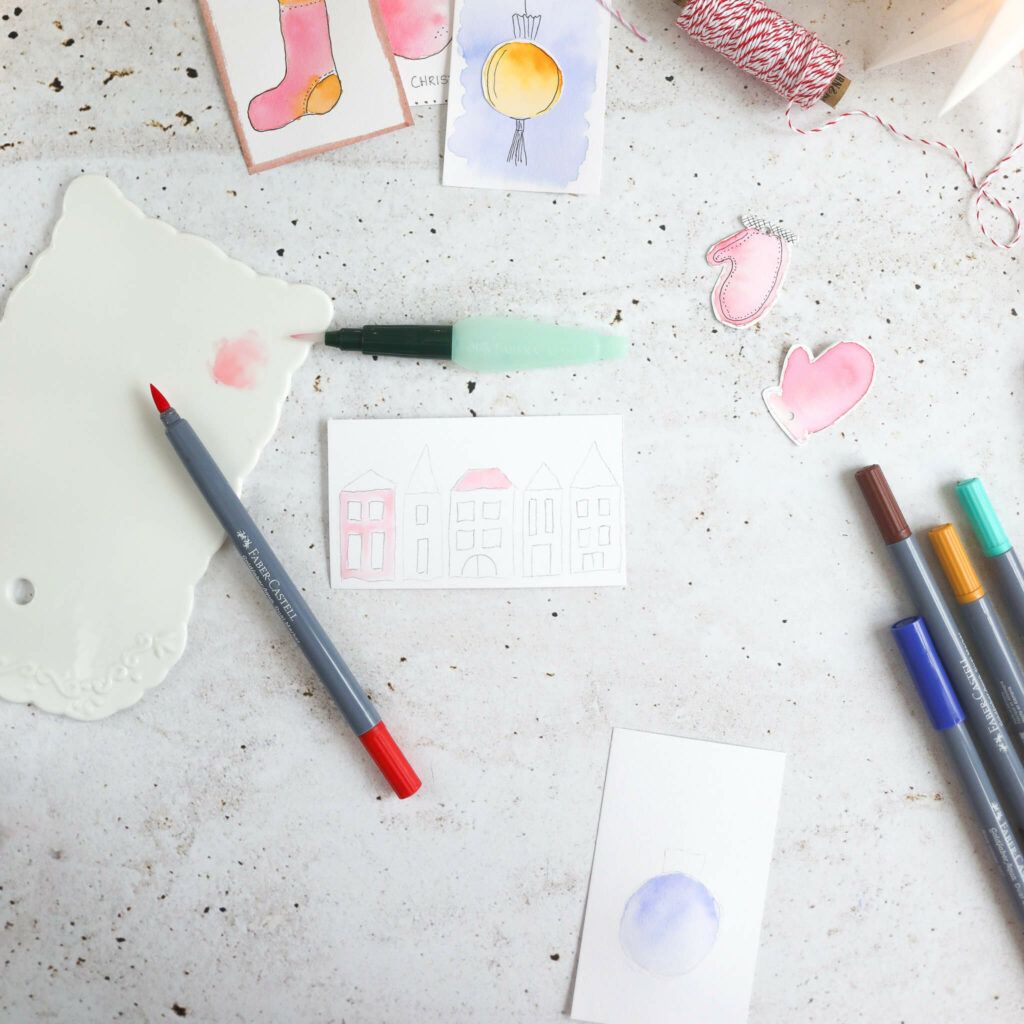 Häuser mit Aquarellfarben auf Papier aufmalen